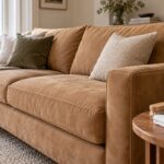 Tan suede sofa with a soft upholstery brush and dry white cloth on a side table